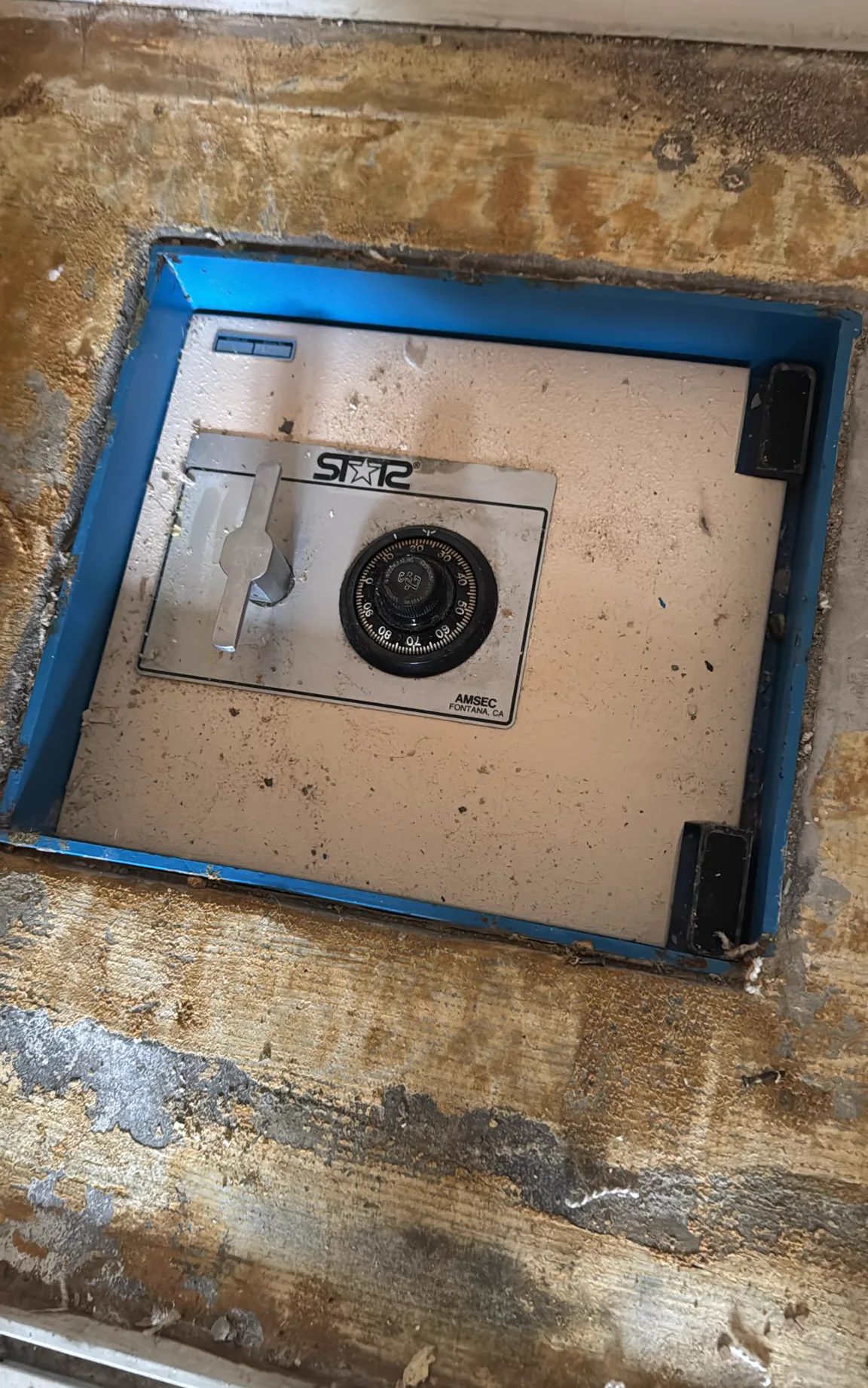 Floor safe being installed and anchored into a concrete slab
