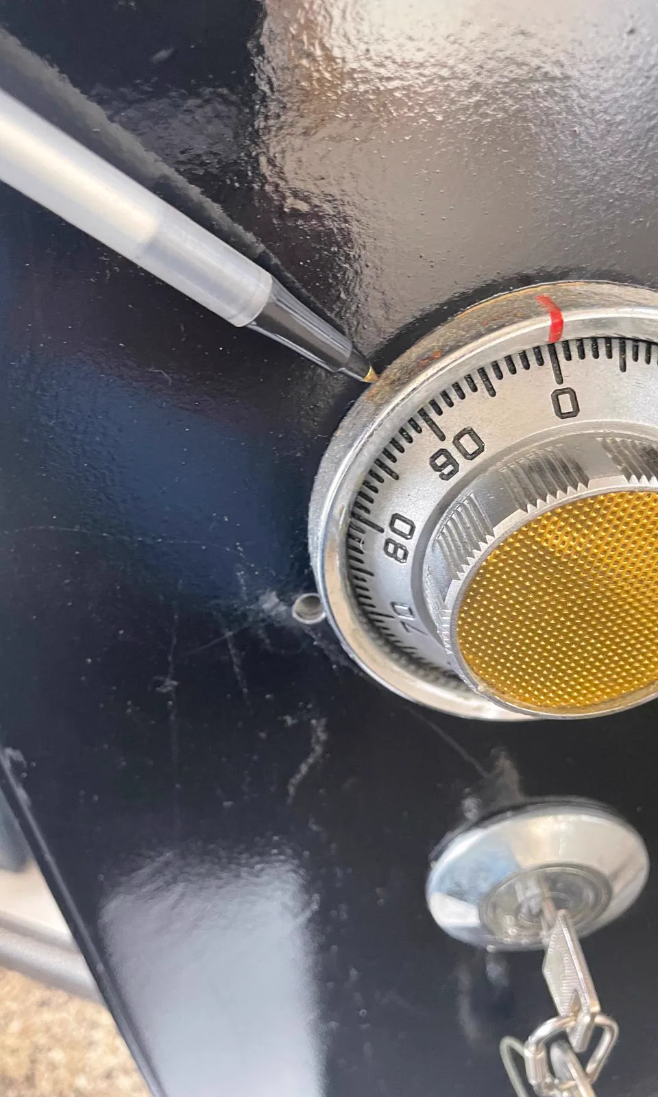 Safe technician manipulating a combination dial on a locked safe