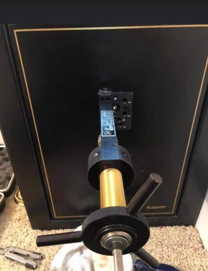 Drill rig mounted on a SentrySafe door during a professional opening
