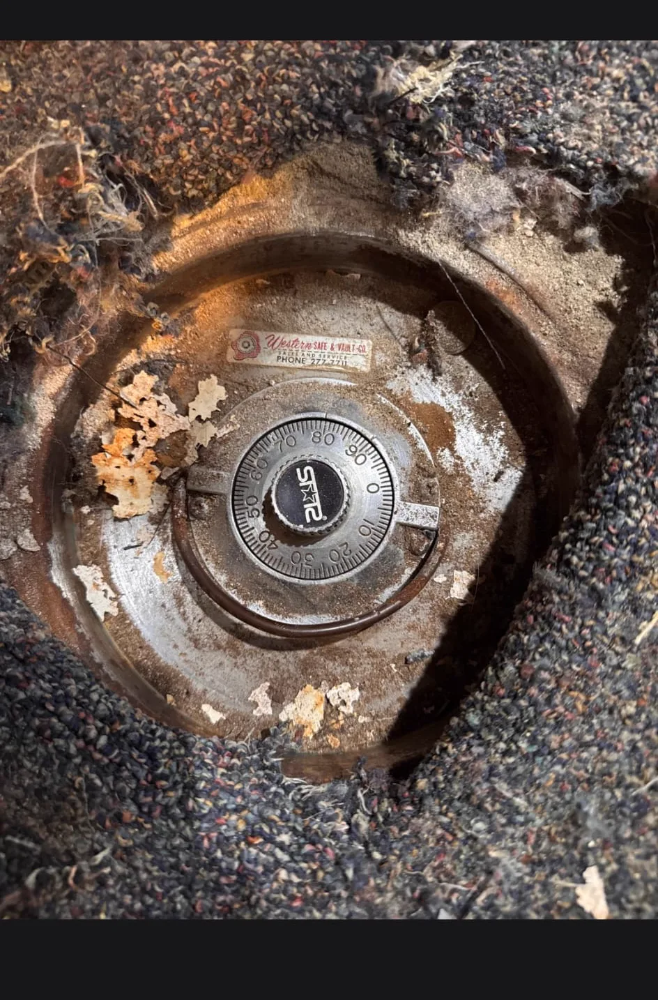 Vintage floor safe with round lid uncovered beneath the flooring of an older home